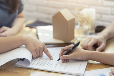 woman putting signature on document